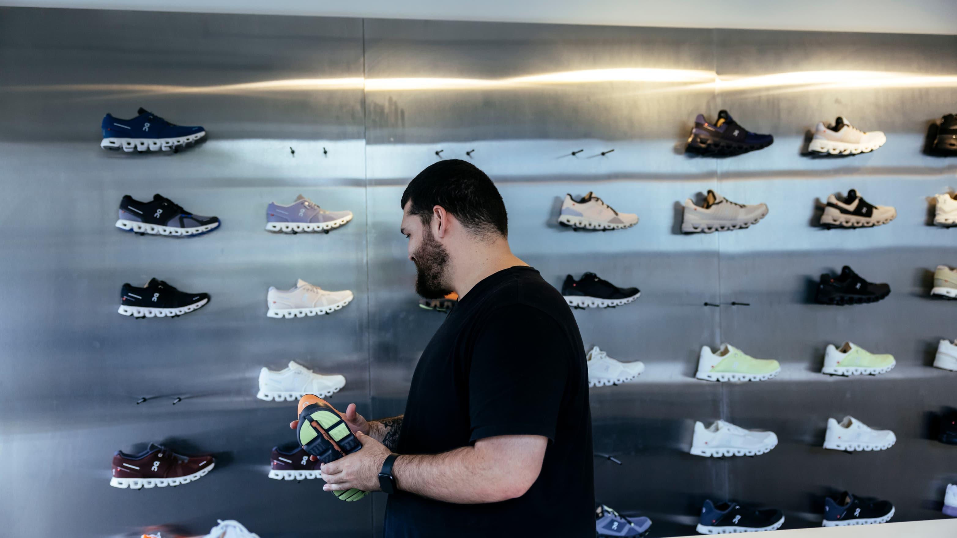 A shopper looks at shoes in a store