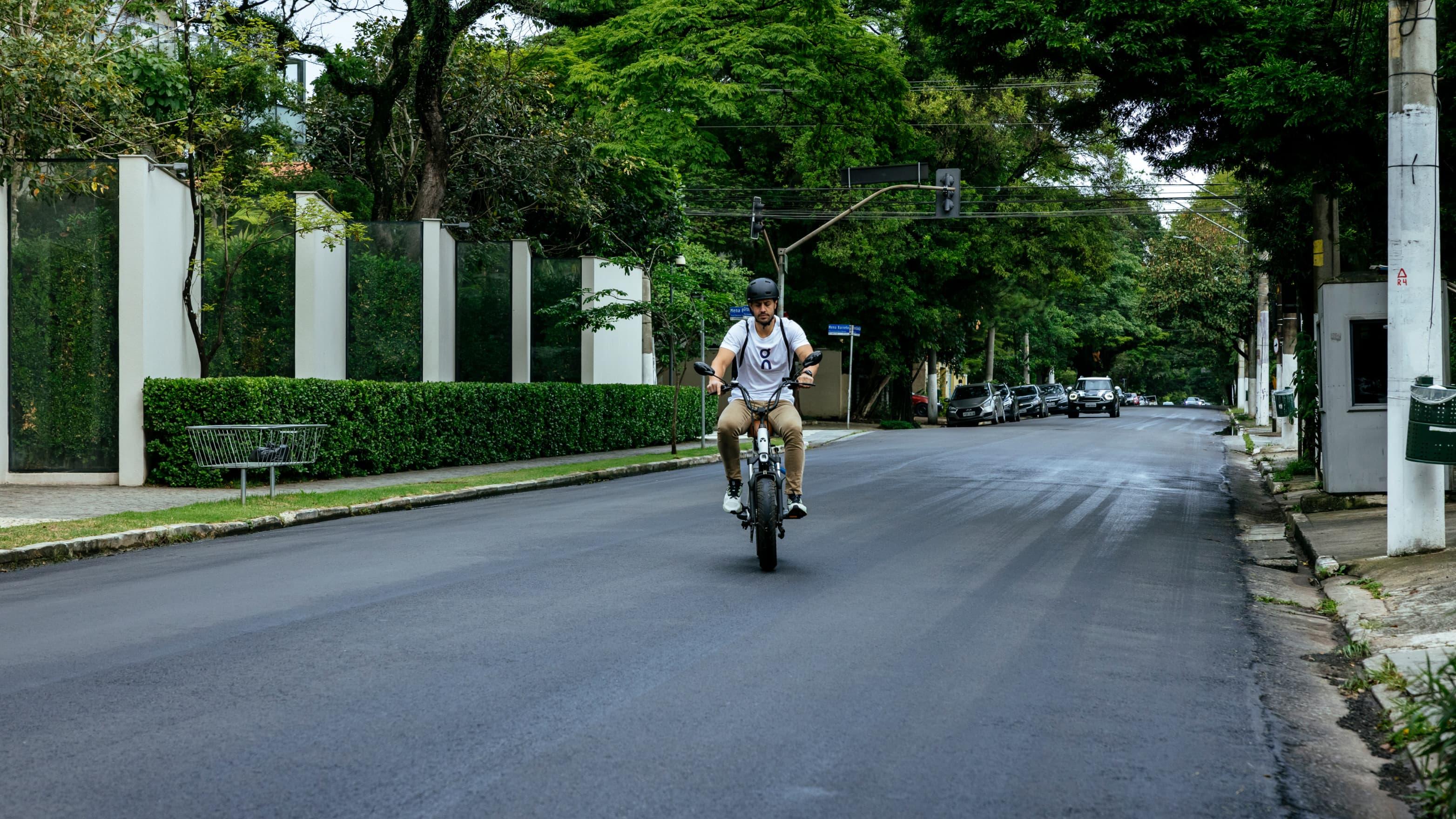 A man rides his bicycle on a street