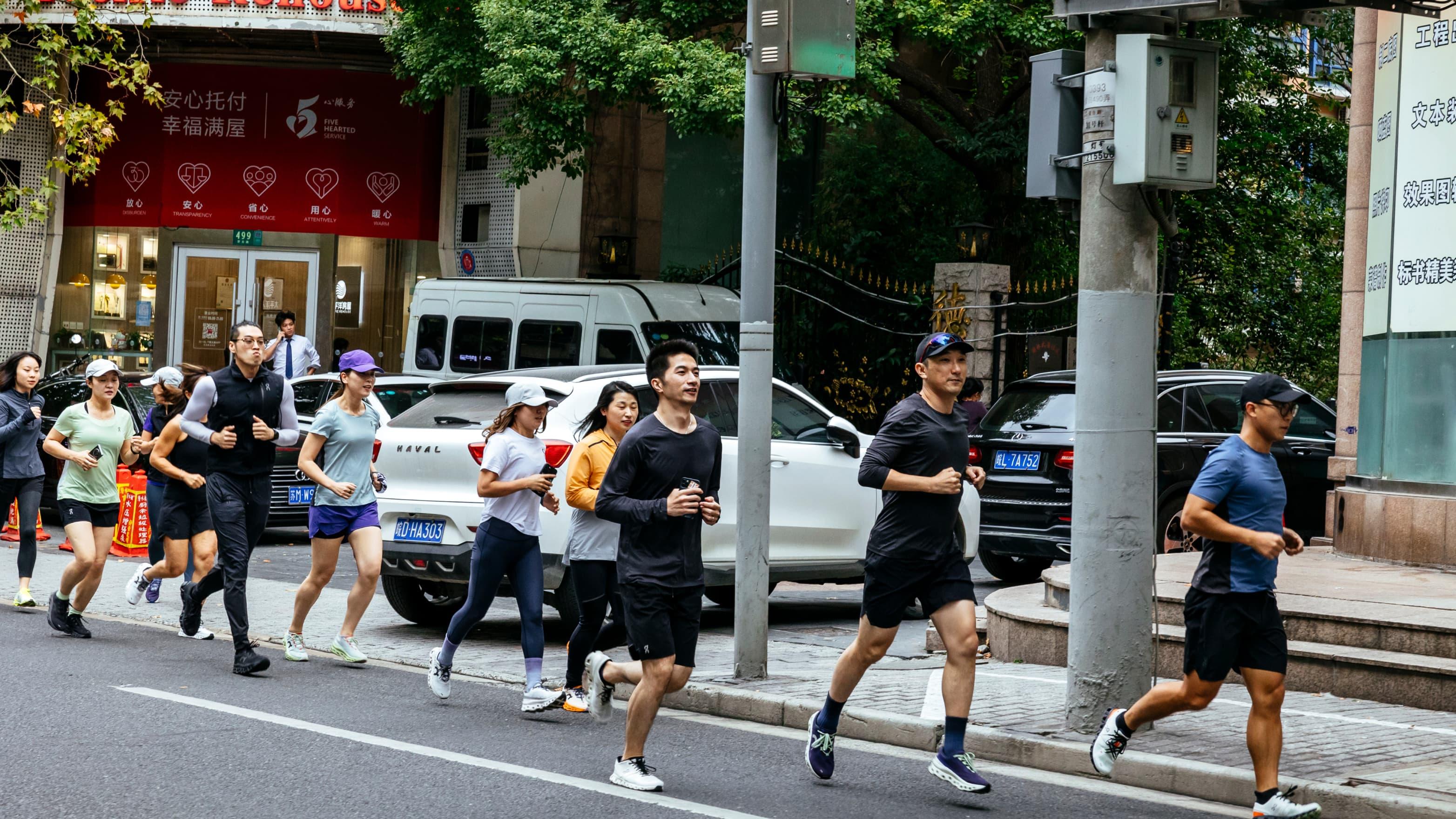 A group of athletes running through the streets of the city