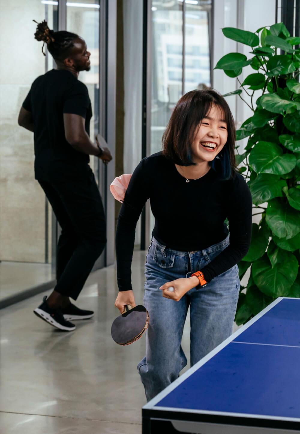 woman smiling playing table tennis
