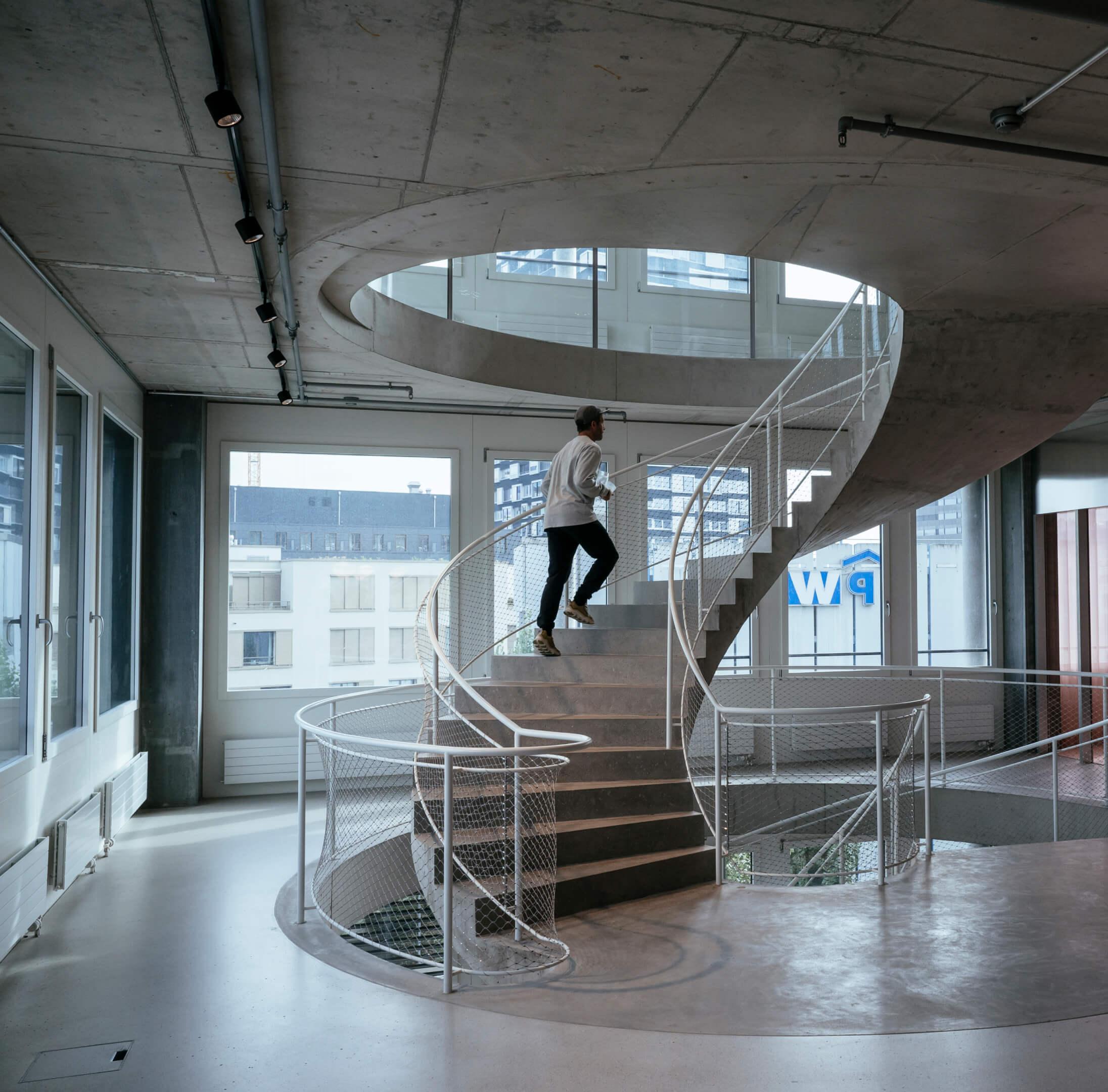 A man running up a spiral staircase