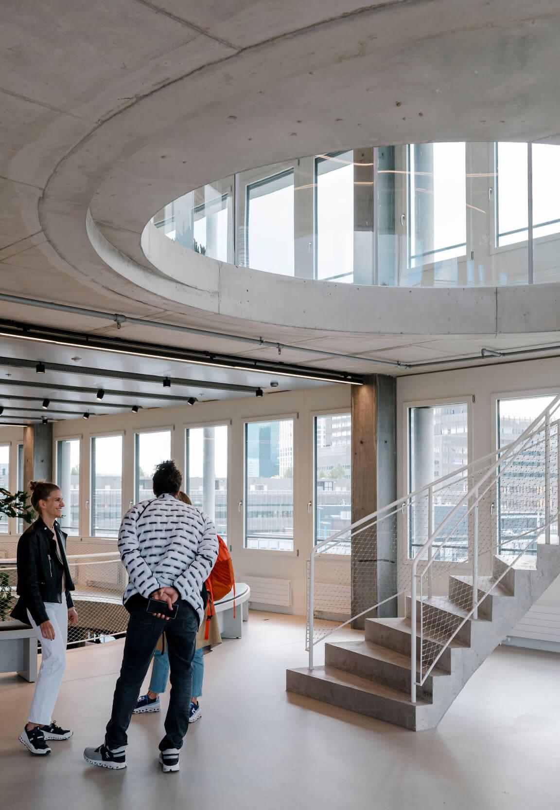 modern office staircase with employees chatting