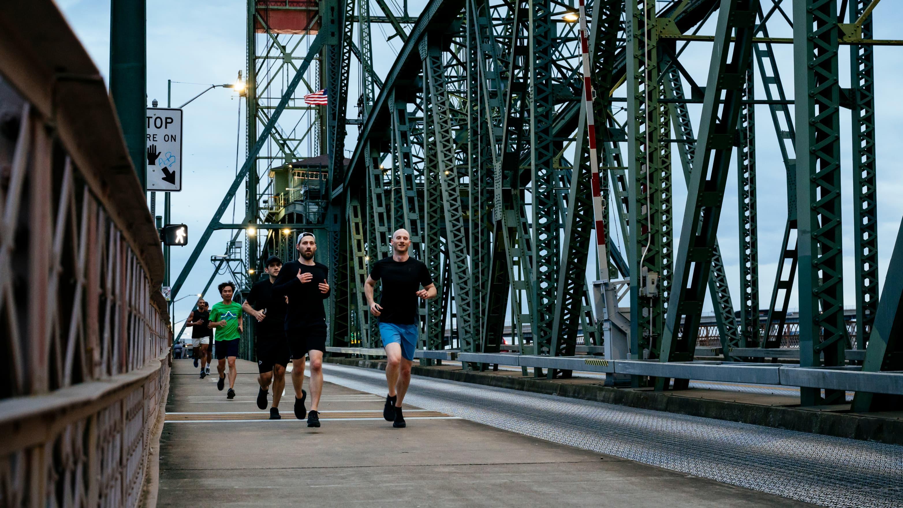 A group of runners runs across the Portland Bridge 